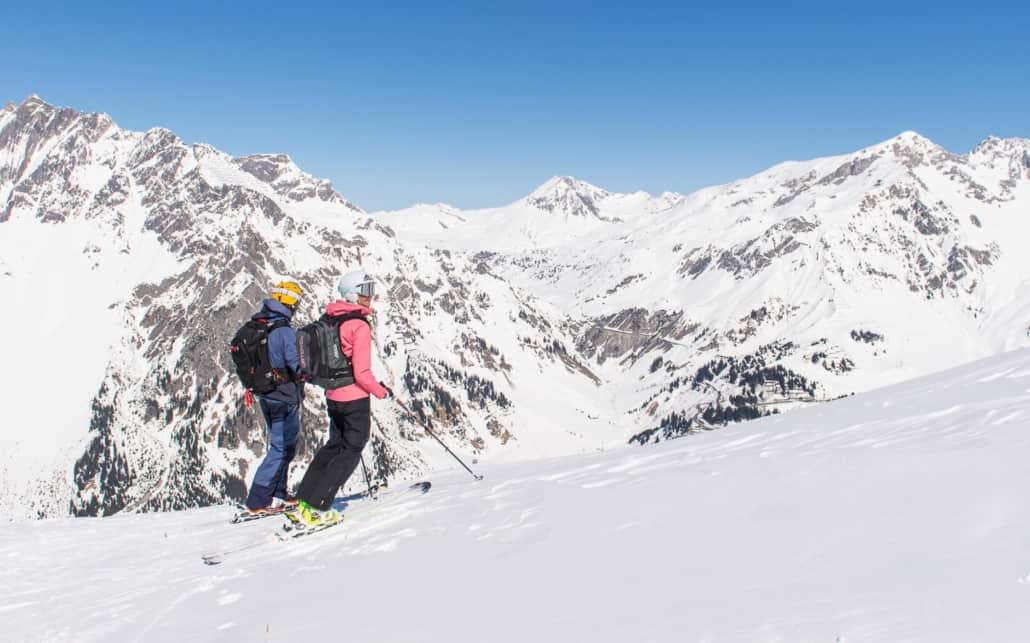 Two Skiers take in a beautiful view on the Arlberg's Albona mountain near Stuben.